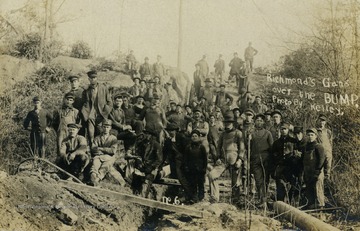 Workers pose for a picture on the bump around recently laid pipeline. See original for correspondence. (From postcard collection legacy system--subject.)