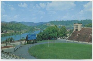 Postcard reads, "Beautifully located overlooking the Monongahela River. This stadium, the home field of the West Virginia Mountaineers, seats 34,000 spectators." Published by Valley News Agency, Inc. (From postcard collection legacy system--subject.)