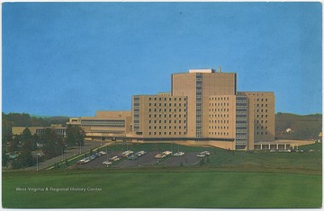 Postcard reads, "The West Virginia Unviersity Medical Center, with the Basic Sciences Building on the left and the University Hospital on the right, is one of the finest and most modern medical centers in the world. There are 3,412 rooms in this single structure." Published by Walter H. Miller  &amp; Co., Inc. (From postcard collection legacy system--subject.)