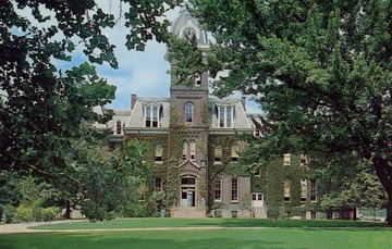 Caption on back of postcard reads: "One of the oldest buildings on the campus, built in 1876. Several of the departments of the College of Arts and Sciences are located here. Martin and Sciences Hall are other landmarks located on Woodburn Circle." Published by Valley News Agency. (From postcard collection legacy system--WVU.)