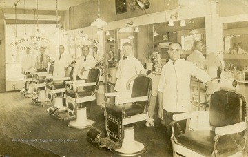 Easel Harper is the barber in second chair back from the front. (From postcard collection legacy system--subject.)