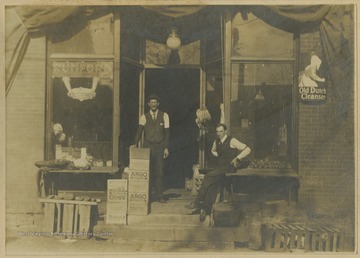 Two unidentified men pose outside of a shop on High Street.