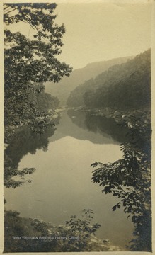 Back of the photo reads, "When it comes to scenery, the West Virginia hills have them all beat. This is Cheat River."