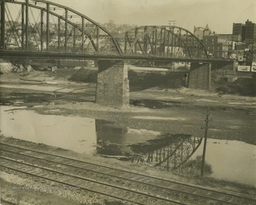 Photo showing dried up river beneath the bridge that connects into Morgantown, W. Va.