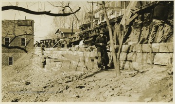Men work along the wall on Richwood.