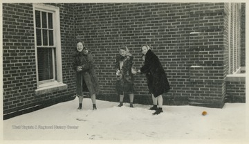 Female students play in the snow covered roof garden on top of what is now known as Stalnaker Hall at West Virginia University. 