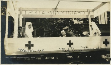 Children dressed as nurses and soldiers ride on the parade float in Morgantown, W. Va.