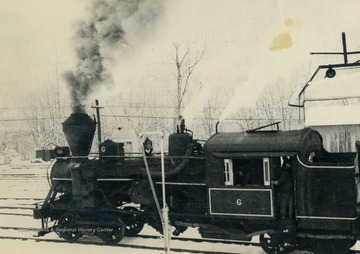 Diesel train on route to Cass travels through snow in mid winter.