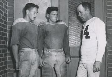 McLaughlin, pictured on the right, speaks with two of his Alderson High School players. He coached and taught at the school from 1936 to 1962.