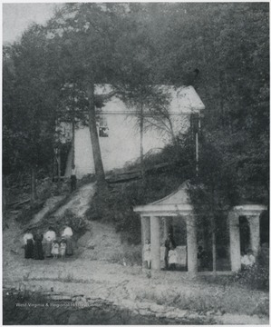 People pictured in front of the home and inside the gazebo on the grounds. No subjects identified. 