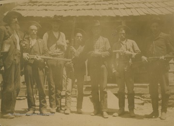 Anderson, pictured to the left, carries a pistol while the rest of his colleagues hold shotguns.