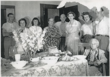 Pictured from left to right, Billy Joe Farley, Mrs. Dewey Farley Lester, Irene Farley Dobbins, Mrs. Farley (first name not provided), Mr. Farley (first name not provided), unidentified, Mrs. Orb Farley, Orb Farley, and Grandma Farley.