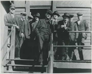 Unidentified men pose outside the office building.
