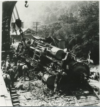 Unidentified workers inspect the damage. 