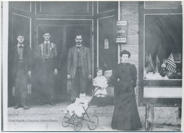A group poses in front of a store. Subjects unidentified. 