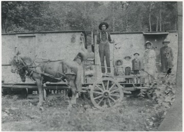 Right to left: Lou Maddy, his wife, Russell Maddy, Etta Maddy, Myrtle Maddy, and Cleaveland Merrix standing on the cart.