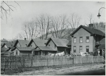 A row of houses with the Greenbrier School in the background to the left. 