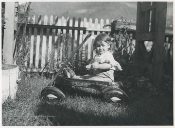 Little David pictured in a wagon behind the home near Hinton, W. Va.