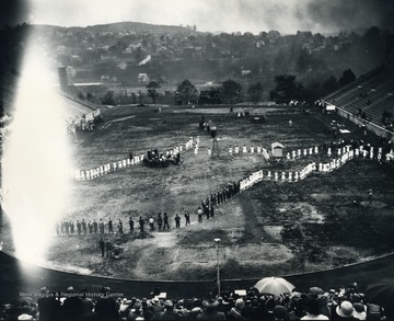 Print number 1079. People lined up in a way that forms the shape of the state of West Virginia.