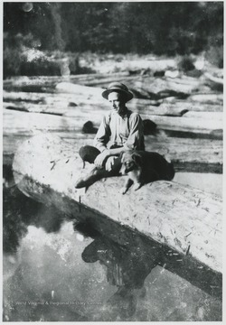 Cook pictured sitting on a log on the Guyandotte River.