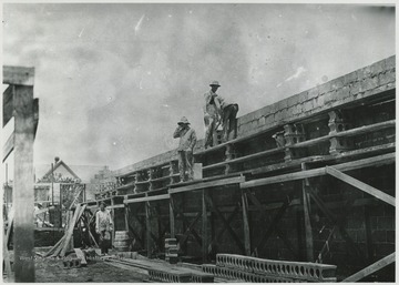 Workers laying brick for the building. Subjects unidentified. 