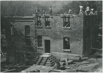 Workers laying brick at the construction site. Subjects unidentified. 