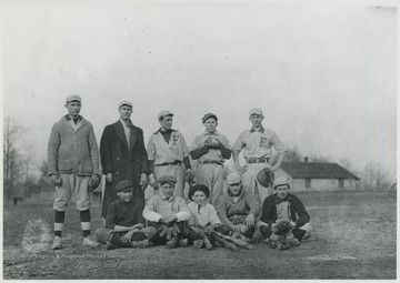 Players pose with baseball bats and gloves. Subjects unidentified. 