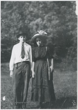 The couple are pictured in a field. 