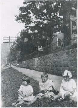 Buster pictured with two young girls by the sidewalk. The girls are unidentified. 