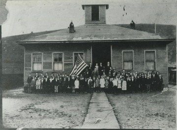 Teachers and students pose in front of the building. This site is now occupied by a Methodist church.