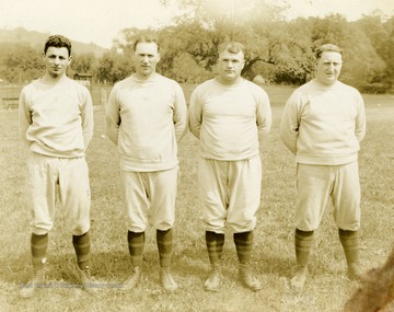Print number 176b. (Coaching staff from left to right): Olikee, MacHenry, Rodgers (Head Coach), Mahan (Line Coach).