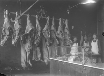 The butcher shop belonged to Clemons Jackson who is pictured in the center of the three people shown.  The young woman pictured is Jackson's daughter, Amanda Jackson, who died shortly after this photograph was taken.  The young man in the image is unidentified.