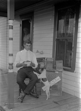 Mail order shipment of groceries sits on the porch. Ray Green is the younger brother of James Green (photographer).