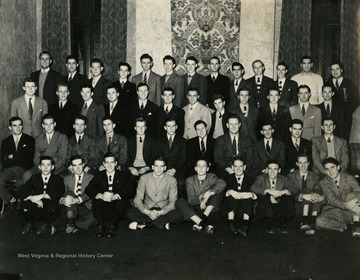 Top row, from left to right: 1. Jack Brown, 2. (?), 3. McIntyre, 4. (?), 5. (?), 6. (?), 7. (?), 8. (?), 9. Allen Sanders, 10. (?), 11. Lyle Gray, 12. Paul Policious, 13. John Nicholas. Second row, from left to right: 1. Bill (?), 2. Don Patterson, 3. John Connell, 4. Don Bond, 5. H.C. Foster, 6. (?), 7. Bob Mollar, 7. McIntyre, 9. (?), 10. (?), 11. "Tiger" Patterson, 12. Char (T.I.) Greene. Third row, from left to right: 1. (?), 2. (?), 3. Jim "Rifa" Wonerte, 4. (?), 5. Dick Clark, 6. Dick Bayne, 7. Ray Goodwin, 8. Dr. Ted Brown, 9. (?), 10. Char Ruch, 11. Don Nicholl. Bottom row, from left to right: 1. (?), 2. (?), 3. (?), 4. (?), 5. (?), 6. Ed Ellin, 7. Lyle Morris, 8. (?), 9. Troy Turnbridge.
