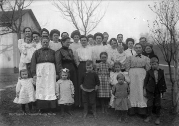 James Green Jr., front center, to his right in checkered dress is Virginia Green,  and behind Virginia is Edith Taylor Green holding a baby.