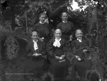 Women in middle holds book titled: "Pentecostal Hymns Number Three".