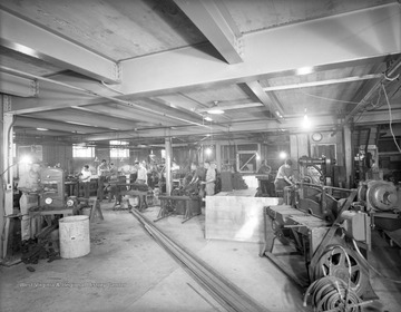Company workers hard at work on a variety of machines.
