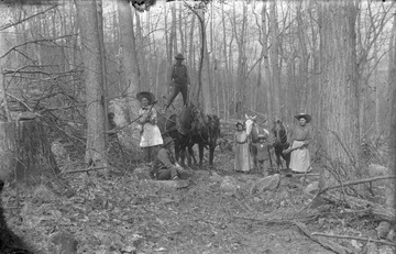 The two women pictured are holding tools, one an axe, preparing for some type of clearing work. Location is mostly likely in or near Preston County.