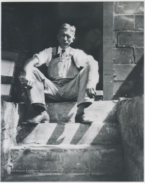 Loomis sits in the doorway of his shop located on Front Street. 