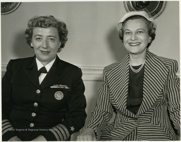 Inscribed on the back of the photo: ' Mrs. Rush D. Holt, DACOWITS member from Charleston, West Virginia and Captain Winifred R. Quick, Assistant Chief of Naval Personnel (Women) (Waves) are pictured in the Department of Defense while attending the April 6-7, 1959 meeting of the Defense Advisory Committee on Women in the Service.'