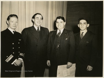 United States Senator Rush D. Holt from West Virginia poses with three unidentified men, one in a U.S. Navy uniform.