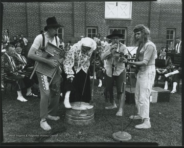 Four musicians in "hillbilly" attire play a variety of instruments, including a washboard (fat left) and a banjo (far right). Subjects unidentified. 