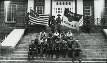 Boy Scout Troop 115 poses on the steps of the building. Subjects unidentified. 