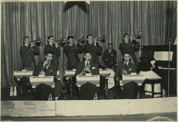 Charles Lago is pictured on the far left playing the saxophone. The other musicians are unidentified. 
