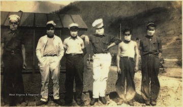 Six unidentified men wearing quarantine masks due to a death from spinal meningitis. The quarantine lasted 30 days for all personnel at the Civilians Conservation Corps (CCC) camp. The CCC constructed projects including bridges, buildings, overnight cabins, retaining walls, roads, dams, towers, picnic areas, and drainage systems.
