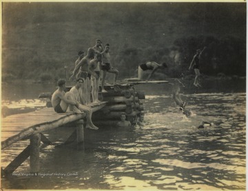 A group of unidentified men spend time by the swimming hole located on the banks of New River. Here, life saving techniques were taught to the members of the Civilians Conservation Corps (CCC).