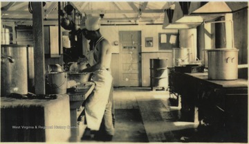 Two unidentified men working in the kitchen. The camp required two cooks per shift of 24 hours followed by 24 hours off. 