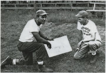 Huffman, left, and Beasley, right, go over plays for the football team. 