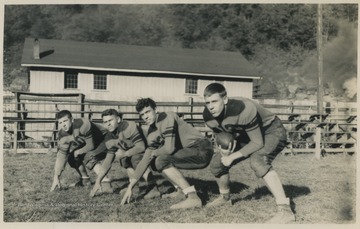 Pictured from left to right, Jack Westfall, Bobby Jack Crush, "Buck" Seldomridge, and Pat Shires. The boys are dressed in their team uniform. The school's mascot is the Bobcats. 