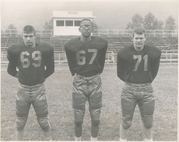 Pictured from left to right, Ed Johnson, Bill McDowell, and an unidentified player. The boys are pictured at Stokes Stadium.